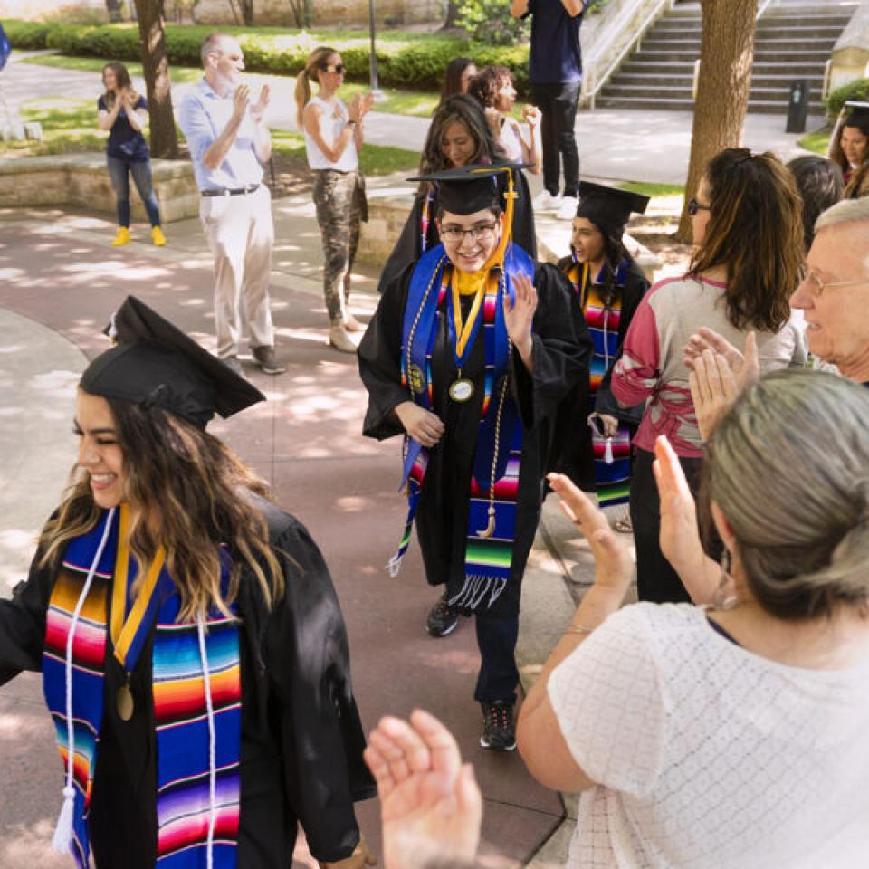 graduates walking around seal