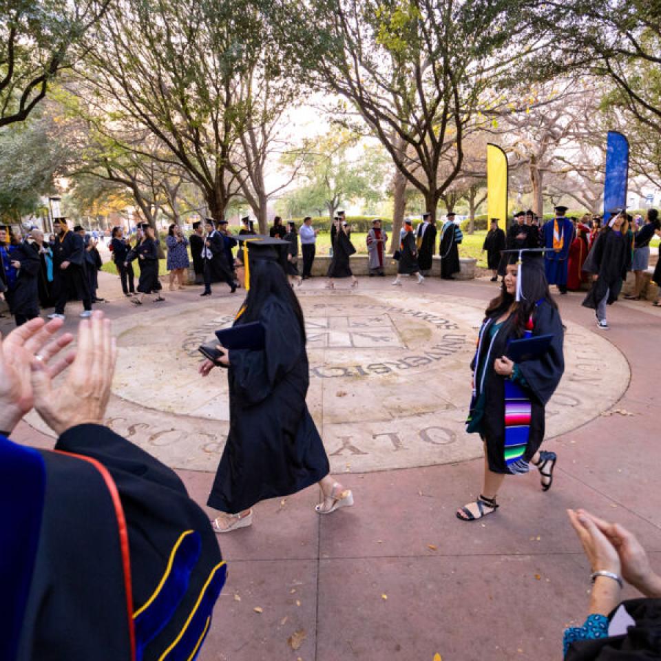 graduates walking around seal