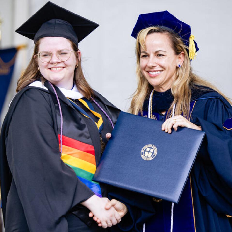 graduate posing with president fuentes