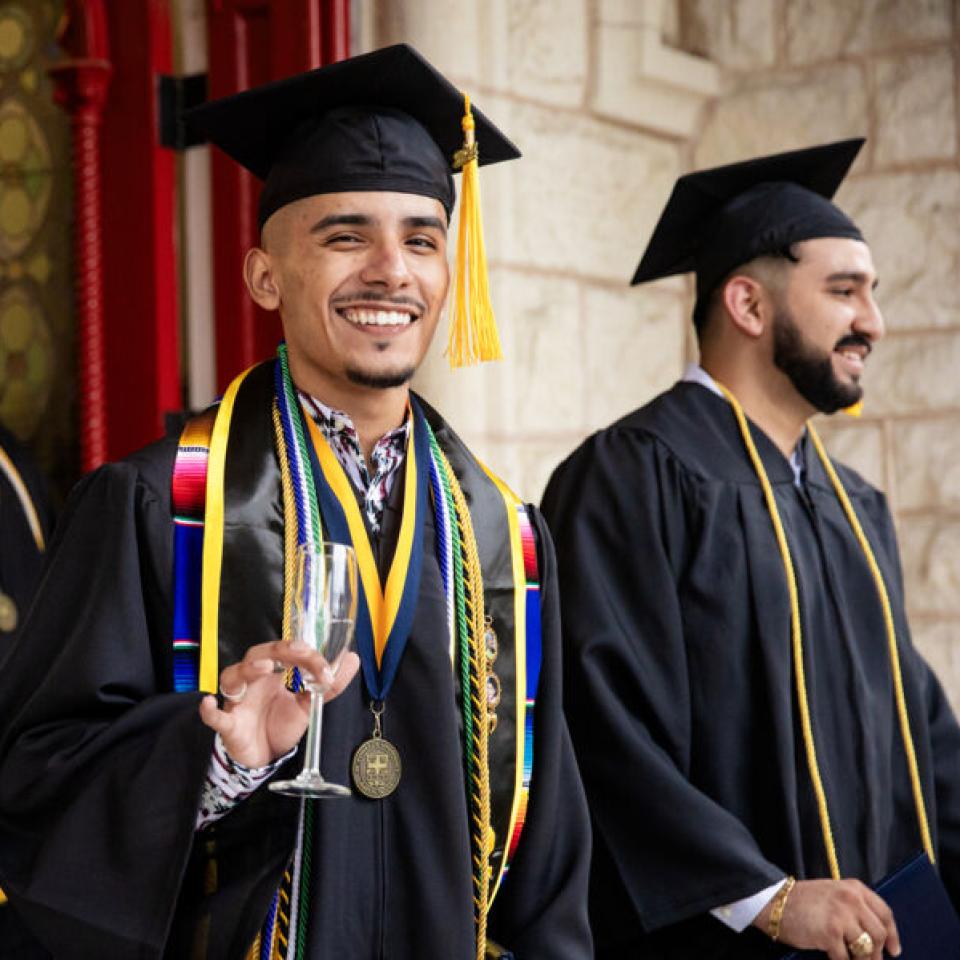 Graduates celebrating at commencement at St. Edward's University