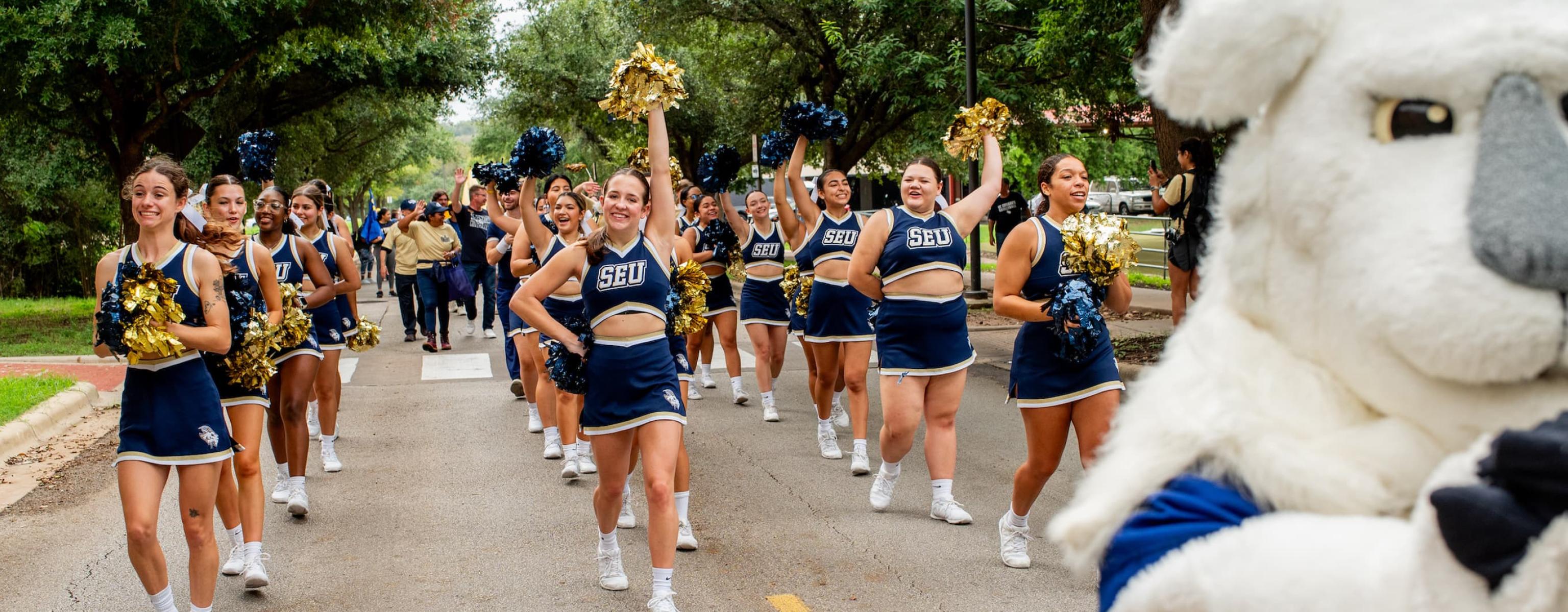 Cheerleaders marching in the Homecoming Parade