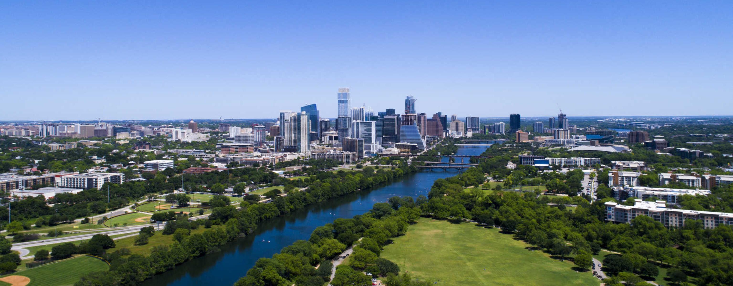 An aerial view of downtown Austin, Lady Bird Lake and Zilker Park.