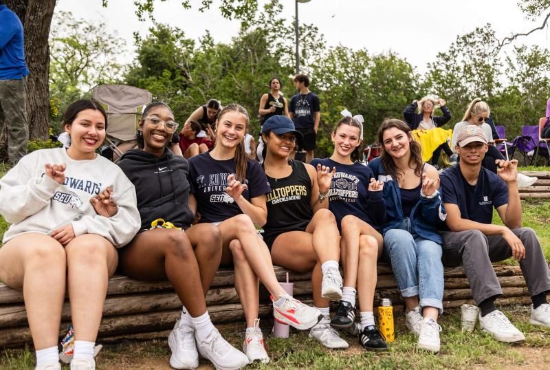 St. Edwards Student through up the Hilltopper hand sign