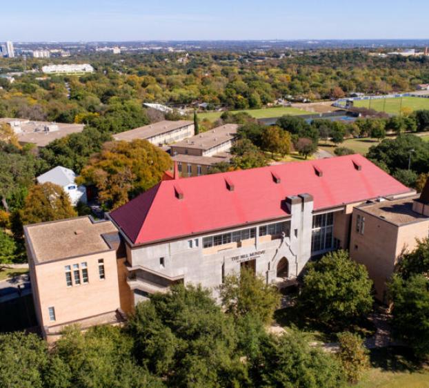 An aerial view of The Bill Munday School of Business and the downtown Austin skyline.