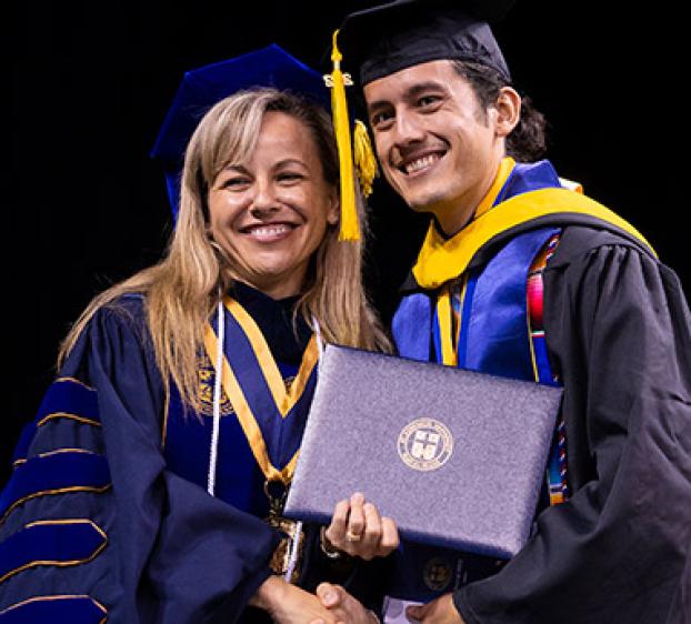 President Fuentes poses with a First-generation graduate.