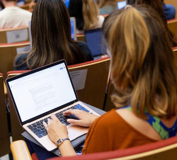 Student on laptop at Lucian Symposium