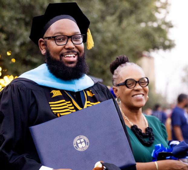 A graduate school student celebrates earning his degree