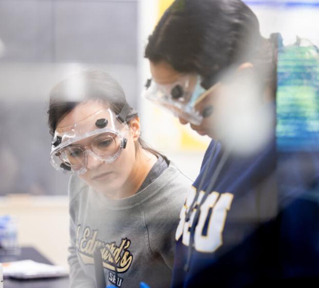 Two St. Edward's University students work together in an analytical experiments lab