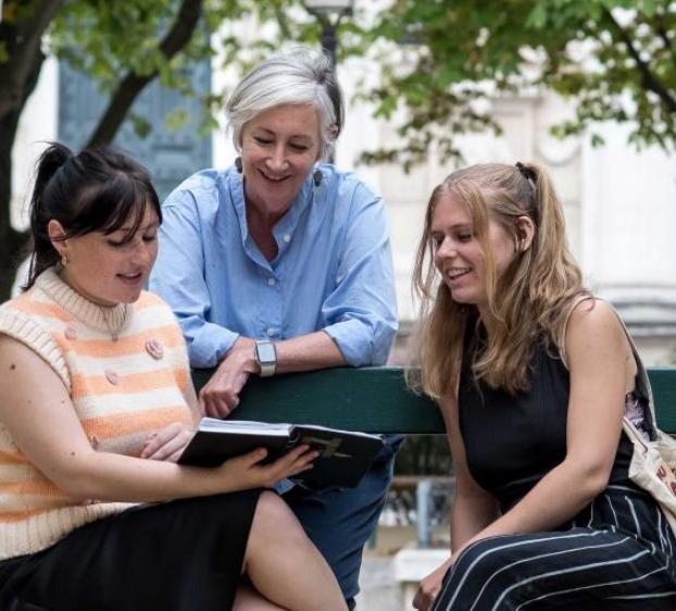 Student and Professor looking at sketch book 