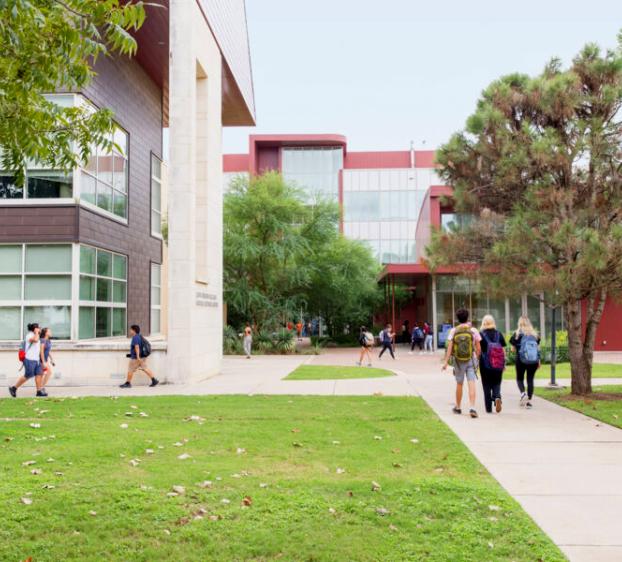 Students walk on paths by the John Brooks Williams Natural Sciences Centers.