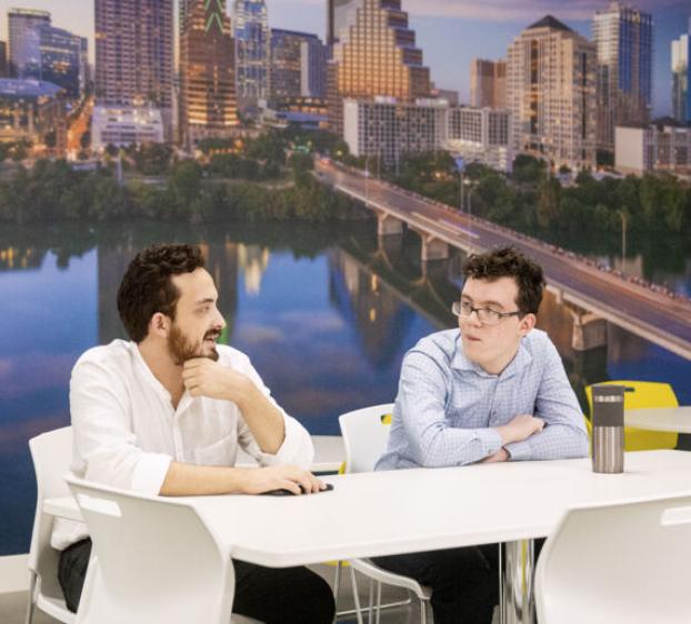 Two students work in an office in downtown Austin