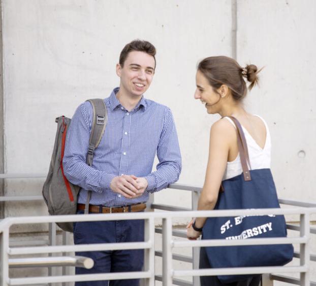 Two St. Ed's graduate students talking together on campus