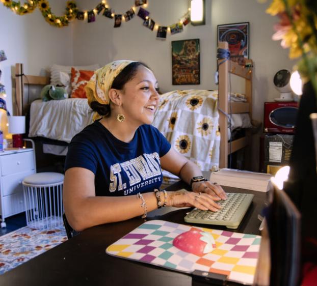 Student studying at their desk in their dorm.