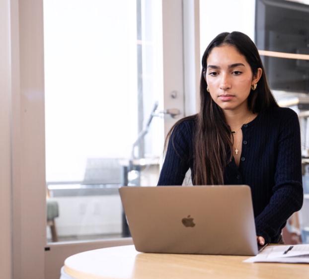 St. Edward's University student using a laptop.