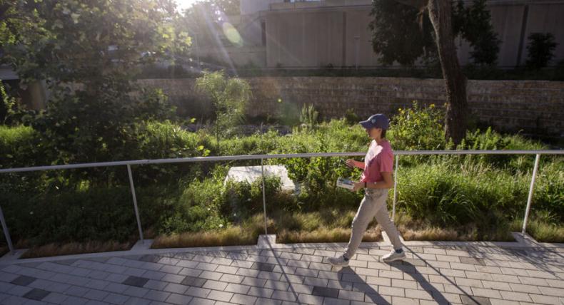 Stella Cunningham walks across a path.