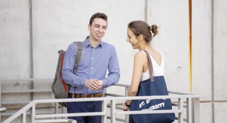 Austin Popa stands with friend Marissa Nicholas on a stairway between classes.