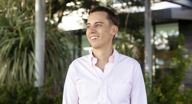 Christoph Hoermann smiles and stands on the Austin Public Library green rooftop patio.