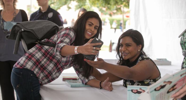 Mindy Kaling taking photo with student at book signing