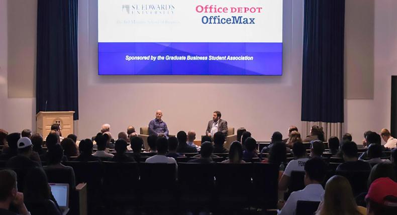 An audience listens to a Munday School of Business fireside chat in Jones Auditorium.