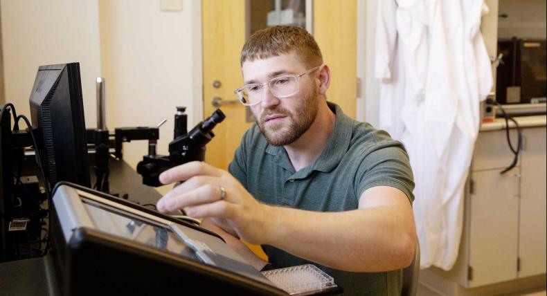 Professor Matthew Steffenson works with equipment in a research lab.