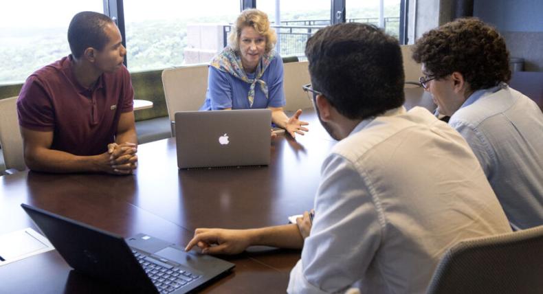 2 students in a downtown conference room during an internship