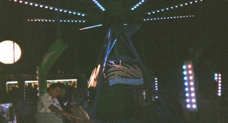 Students ride a ride at night at Hillfest.