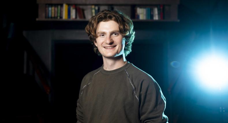 Andrew Mueller stands in the blackbox of the Mary Moody Northen Theatre.