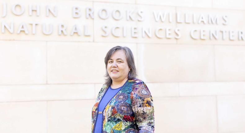 Andrea Holgado stands in front of the John Brooks Williams Natural Sciences Center.