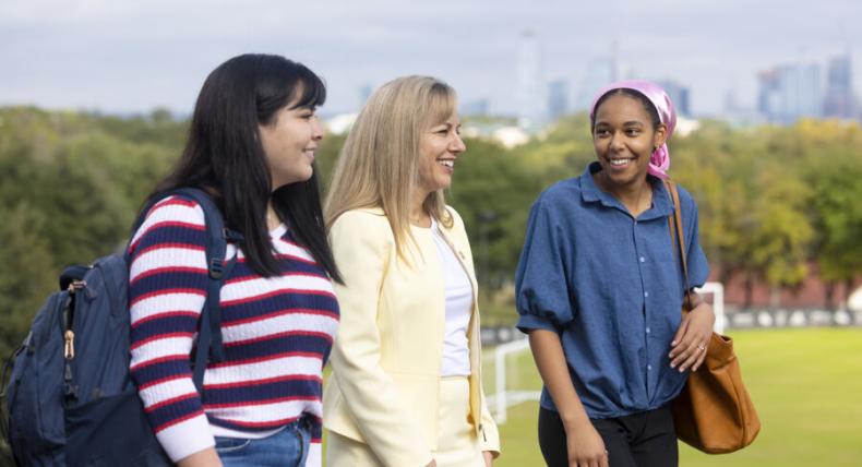 president fuentes walking with students