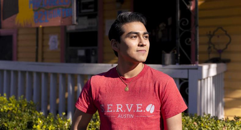 Cristobal Diaz stands outside of Casa Marianella wearing a SERVE shirt.