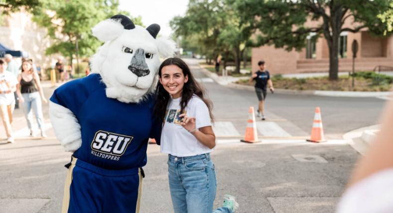 Topper the goat mascot with a student 