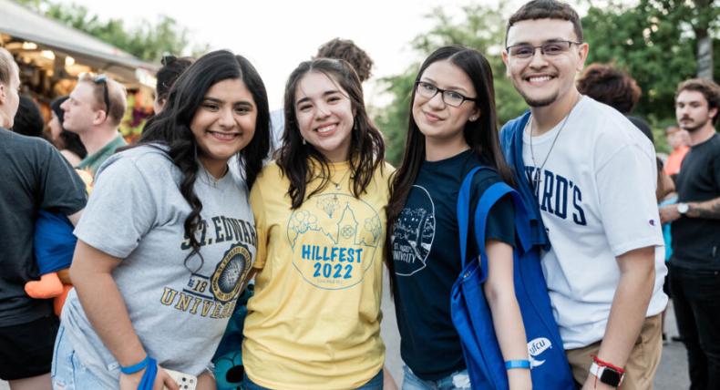 4 st edward's students at a campus event