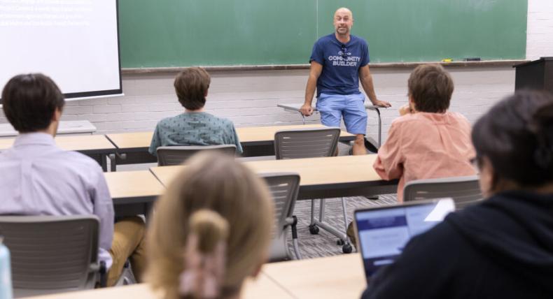 Students at St. Edward's listen intently to a professor leading a classroom discussion. 