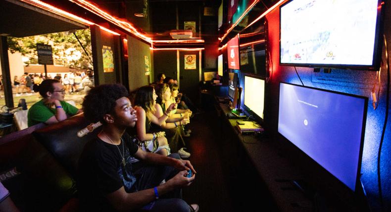 Students play video games at a back-to-school event.