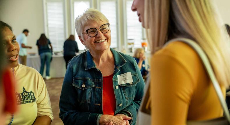 Glenda Ballard speaks with other faculty and staff.