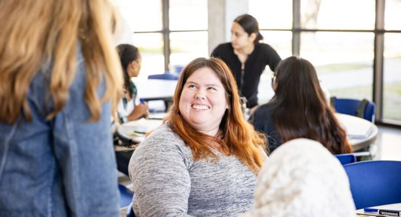 student smiling up at professor