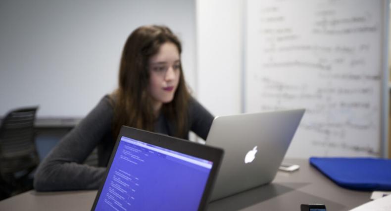 Computer Science student works on her computer during class