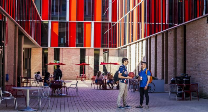 Students gather and socialize in the colorful atrium of the Residential Village on the St. Edward's campus.