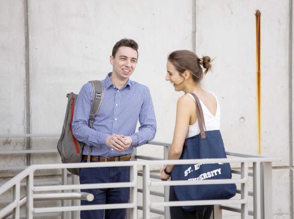 Austin Popa stands with friend Marissa Nicholas on a stairway between classes.