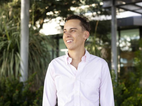 Christoph Hoermann smiles and stands on the Austin Public Library green rooftop patio.