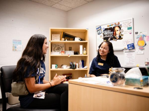 A student meets with a Success Coach in the success coach's office.