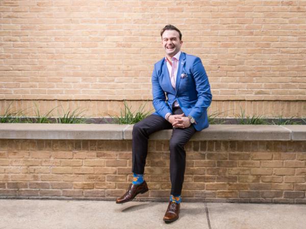 Jeff Miner smiles and sits outside of Trustee Hall.