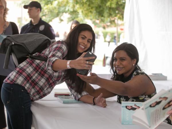 Mindy Kaling taking photo with student at book signing