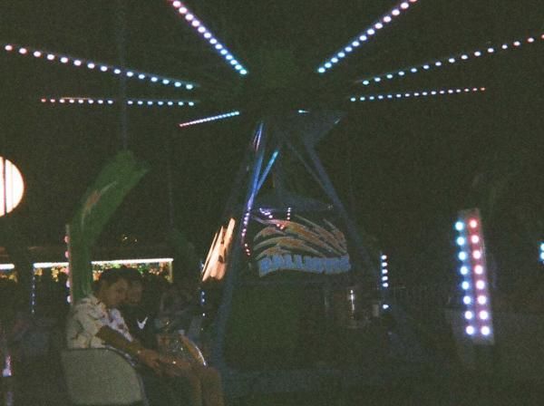 Students ride a ride at night at Hillfest.