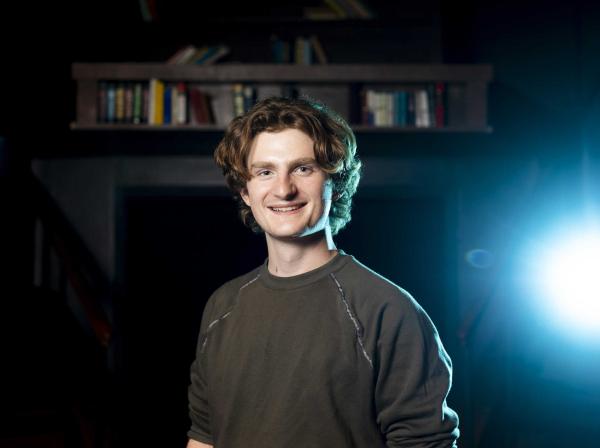 Andrew Mueller stands in the blackbox of the Mary Moody Northen Theatre.