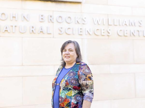 Andrea Holgado stands in front of the John Brooks Williams Natural Sciences Center.