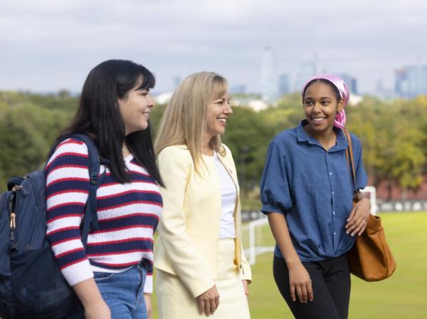 president fuentes walking with students