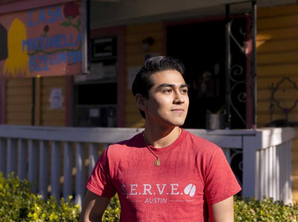 Cristobal Diaz stands outside of Casa Marianella wearing a SERVE shirt.