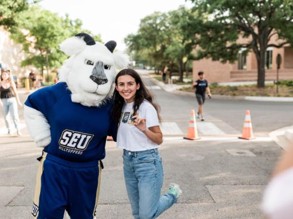 Topper the goat mascot with a student 