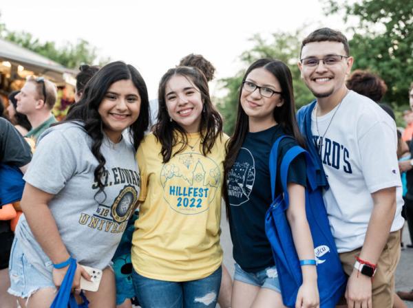 4 st edward's students at a campus event